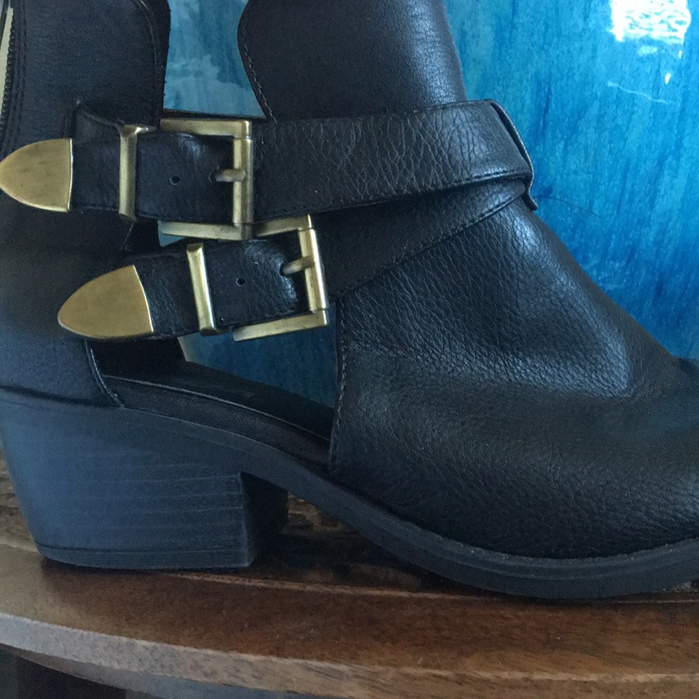 Black heeled booties with gold buckle detail